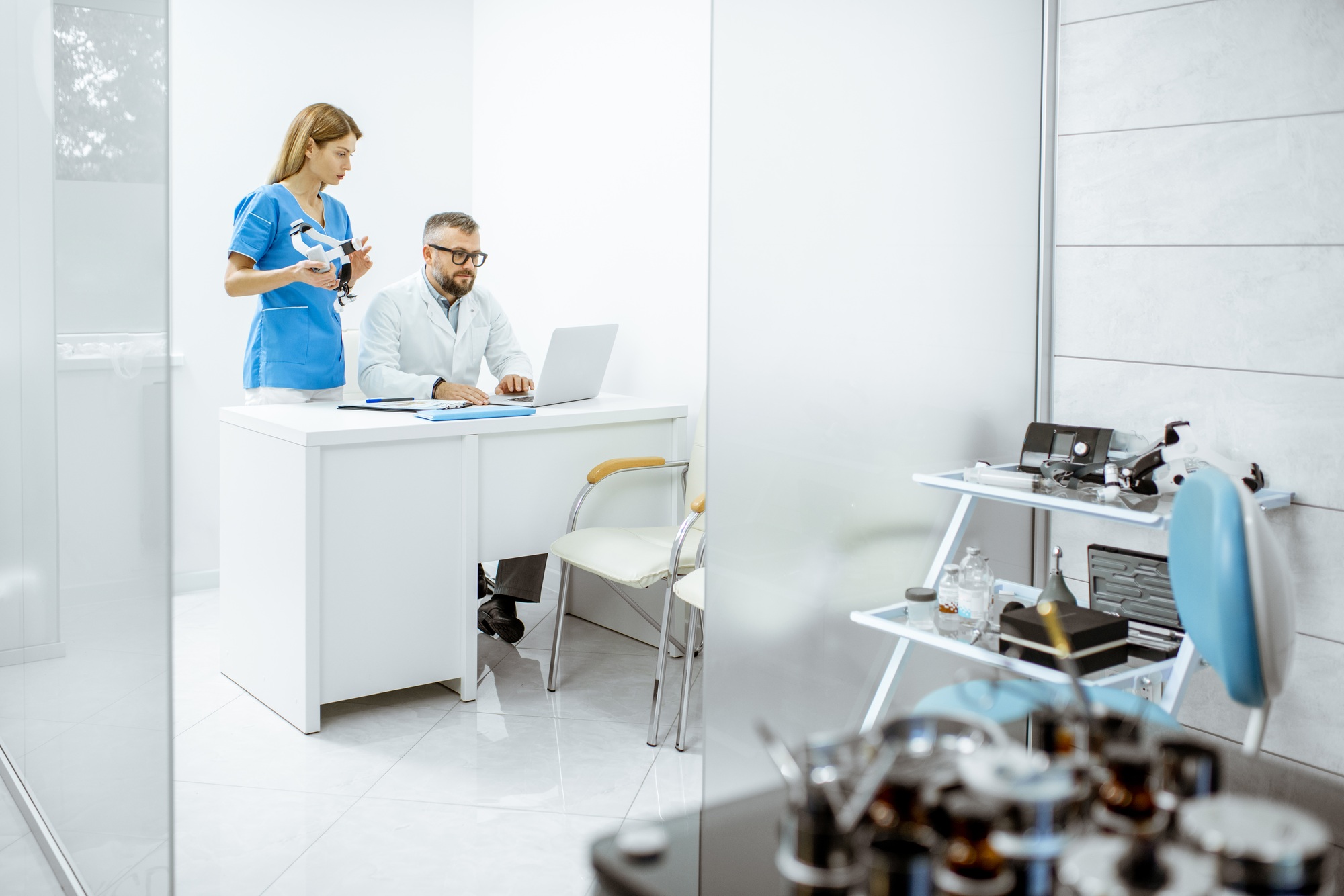 Two doctors working with laptop in the office